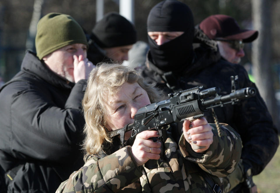 A woman attends a military exercise for territorial defense amid the tension on the border with Russia, in Ukrainian capital Kyiv, Ukraine 13 February 2022. Members of 'Right Sector