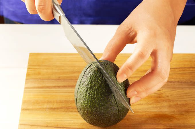 showing how to cut an avocado into quarters