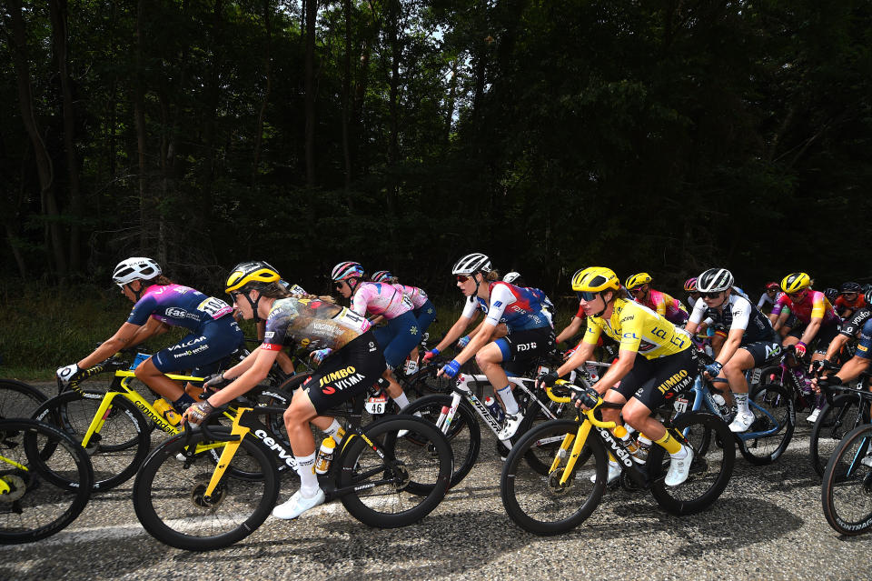 Marianne Vos rides in the peloton in the yellow jersey