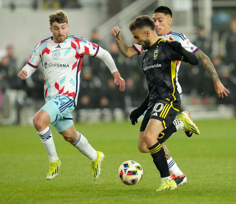 March 9, 2024; Columbus, Ohio, USA; 
Columbus Crew forward Diego Rossi (10) is pursued by Chicago Fire defender Jonathan Dean (24) and Chicago Fire midfielder Federico Navarro (31) during the second half of a soccer match Saturday at Lower.com Field. The Columbus Crew beat the Chicago Fire 2-1.