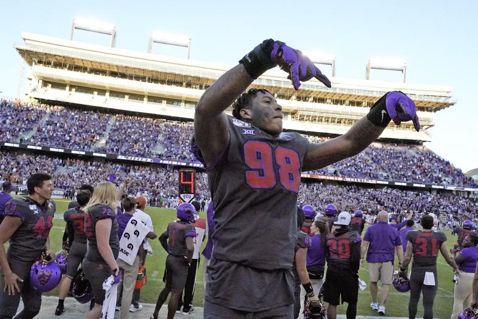 TCU defensive end Adam Plant Jr. (98) celebrates in the bench area during the final seconds of an NCAA college football game against Texas in Fort Worth, Texas, Saturday, Oct. 26, 2019. (AP Photo/Louis DeLuca)