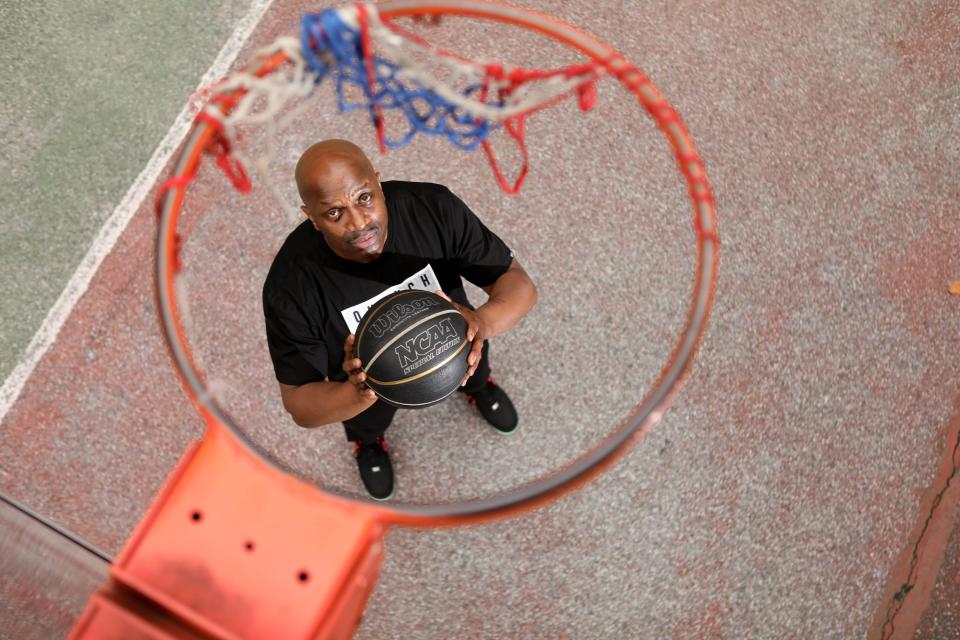 Jermaine Grant on the basketball court beside St. Nicholas Houses, a public housing project where he grew up and lived in 1998. "The Cage" as the court is referred to, is located in Central Harlem.