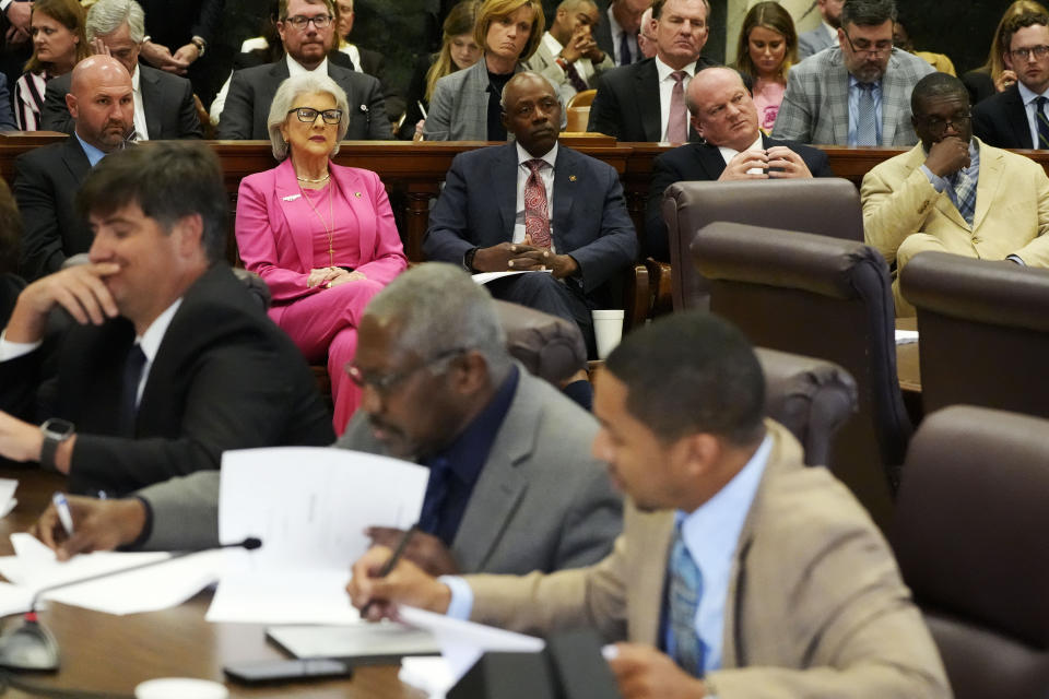 Mississippi State Sens. Philman Ladner, R-Pass Christian, left, Robin Robinson, R-Laurel, second from left, Gary Brumfield, D-Magnolia, center, Brice Wiggins, R-Pascagoula , second from right and Juan Barnett, D-Heidelberg observe the Mississippi Senate Medicaid Committee, foreground, as they consider a proposal to expand Medicaid benefits to tens of thousands of residents, during its meeting, Wednesday, March 27, 2024, at the state Capitol in Jackson, Miss. (AP Photo/Rogelio V. Solis)