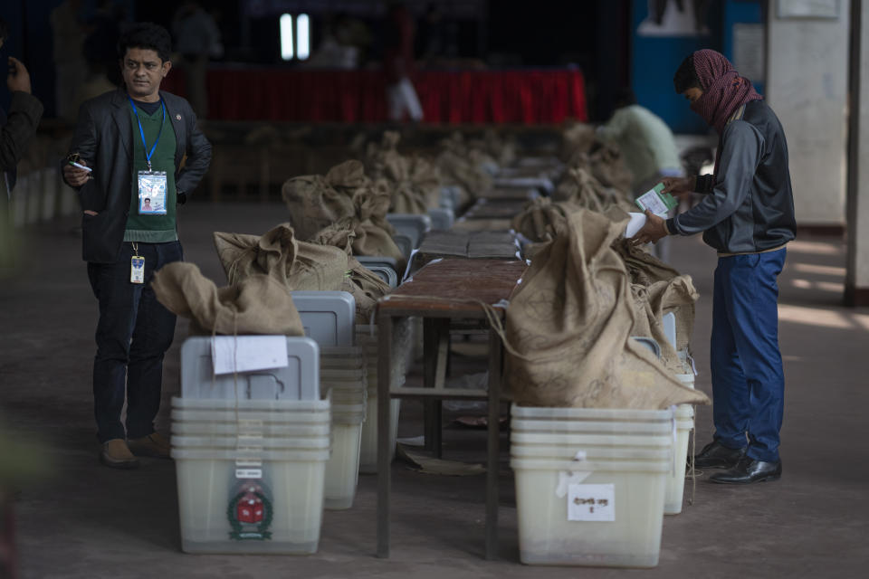 Workers prepare ballot boxes for distribution in an auditorium of a school in Dhaka, Bangladesh, Saturday, Jan. 6, 2024. Bangladesh’s main opposition party has enforced a 48-hour general strike from Saturday across the South Asian nation as the nation is ready to hold its next general election a day later. (AP Photo/Altaf Qadri)