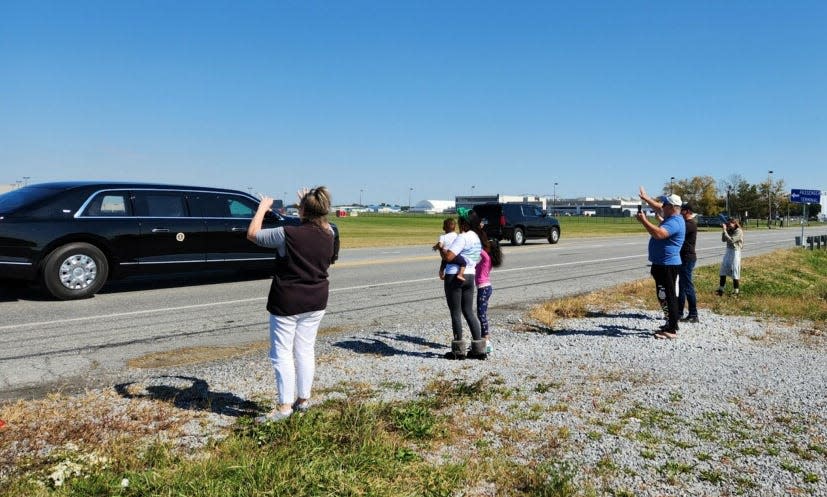 Onlookers watch as President Joe Biden's motorcade passes on Showalter Road as it heads toward the Hagerstown Volvo plant on Thursday, Oct. 7, 2022.