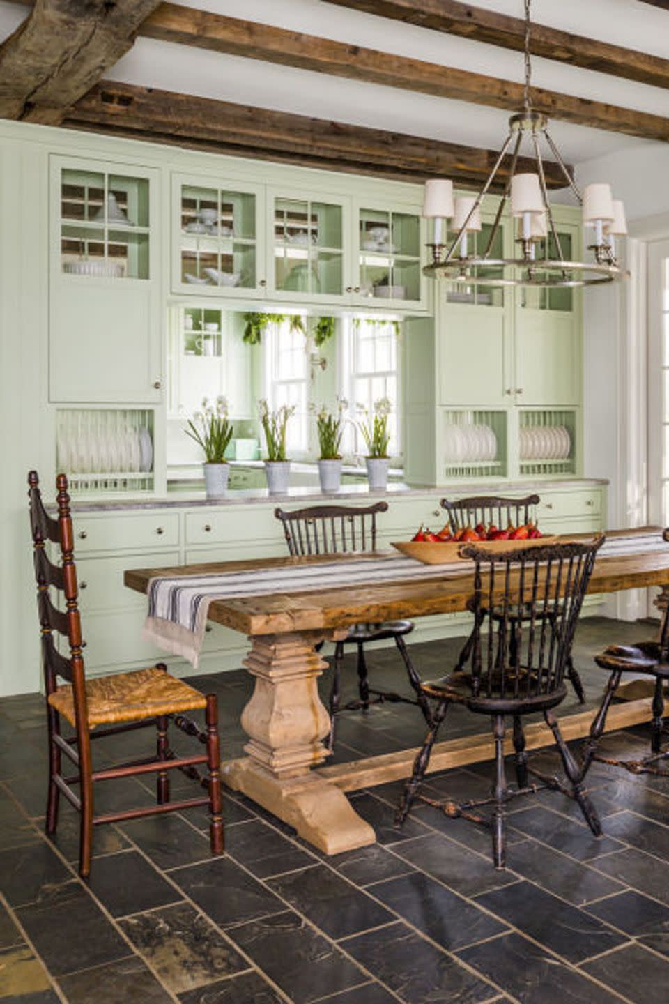 dining room with pine table and green cabinetry