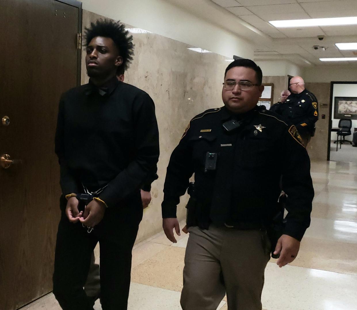 Darius Johnson is escorted out of the 140th District Court on Friday after jurors sentenced him to 20 years in prsion in connection with the shooting death of 39-year-old Steven Colon at his home in Central Lubbock.