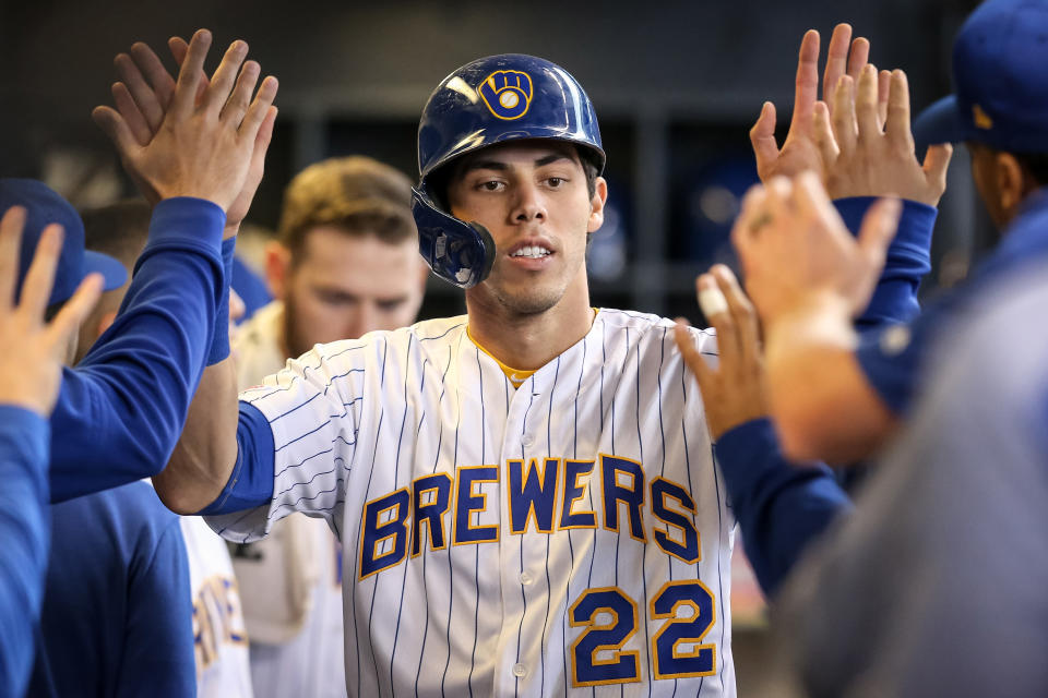 MILWAUKEE, WISCONSIN - SEPTEMBER 08:  Christian Yelich #22 of the Milwaukee Brewers celebrates with teammates after scoring a run in the fourth inning against the Chicago Cubs at Miller Park on September 08, 2019 in Milwaukee, Wisconsin. (Photo by Dylan Buell/Getty Images)