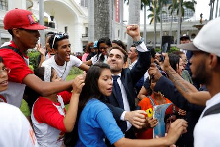 Rafael Lacava (C), newly elected governor of Carabobo state, gestures as he arrives for a ceremony at the National Constituent Assembly at Palacio Federal Legislativo, in Caracas, Venezuela October 18, 2017. REUTERS/Marco Bello