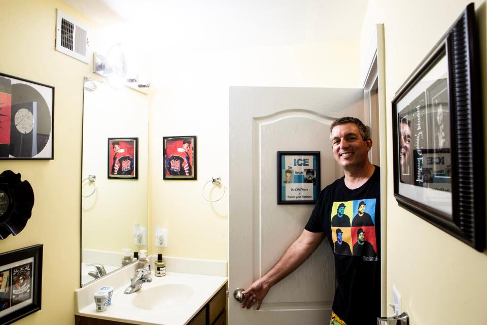 Chad Hastings enters "The Ice House," a bathroom in his home in Magnolia, Monday, July 17, 2023. The bathroom is decorated with memorabilia of rappers Vanilla Ice and Ice Cube.