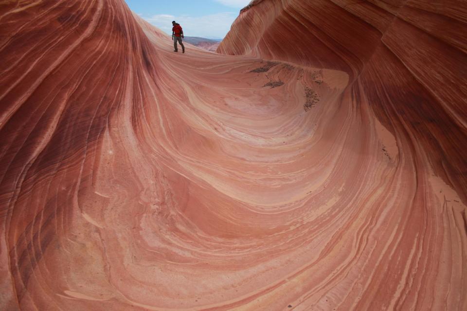This May 28, 2013 photo shows a on a rock formation known as The Wave in the Vermilion Cliffs National Monument in Arizona. The area’s photogenic qualities have made it a popular hike. But permits are only issued by lottery for 20 hikers a day. (AP Photo/Brian Witte)