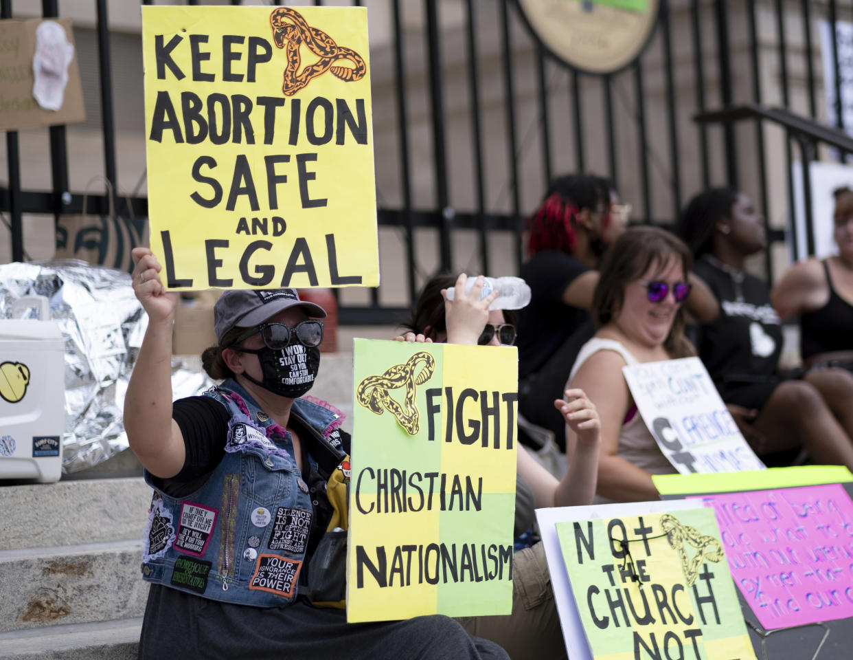 A group sits on the steps of the Georgia state Capitol protesting the overturning of Roe v. Wade on June 26, 2022. (Ben Gray/AP)