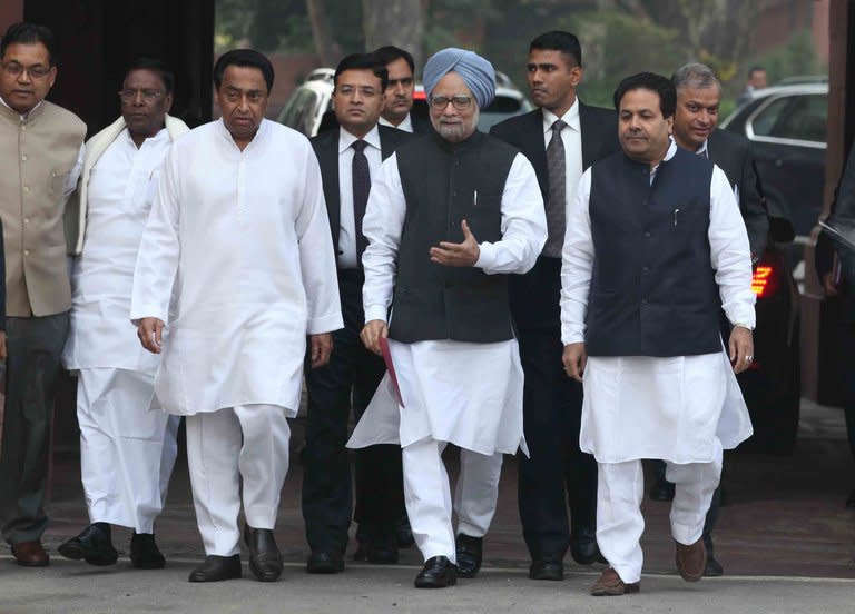 Indian Prime Minister, Manmohan Singh (C), arrives at the Parliament House to attend a session, in New Delhi, on November 22, 2012. Singh on Thursday urged lawmakers to engage in 'responsible' debate as the government seeks to push the annual budget and controversial economic reforms to spur the economy through parliament