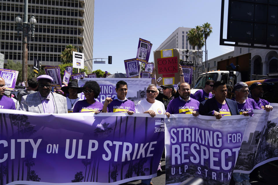 Workers march Tuesday, Aug. 8, 2023, in Los Angeles. Thousands of Los Angeles city employees, including sanitation workers, engineers and traffic officers, walked off the job for a 24-hour strike alleging unfair labor practices. The union said its members voted to authorize the walkout because the city has failed to bargain in good faith and also engaged in labor practices that restricted employee and union rights. (AP Photo/Ryan Sun)