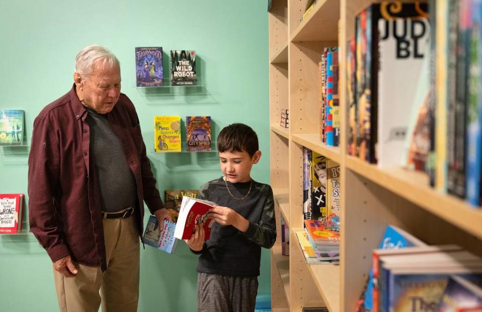 Byron Gregerson y su nieto Lucca, de 9 años, hojean libros en Bookish en Modesto, California, el martes 4 de abril de 2024.