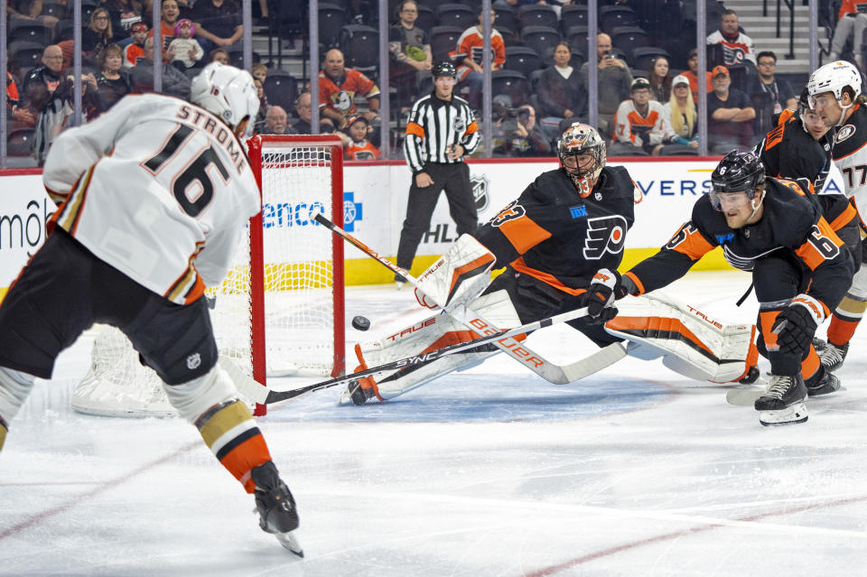 Anaheim Ducks' Ryan Strome, left, shoots the puck past Philadelphia Flyers' Samuel Ersson, center, and Travis Sanheim, right, for a goal during the first period of an NHL hockey game, Saturday, Oct. 28, 2023, in Philadelphia. (AP Photo/Chris Szagola)