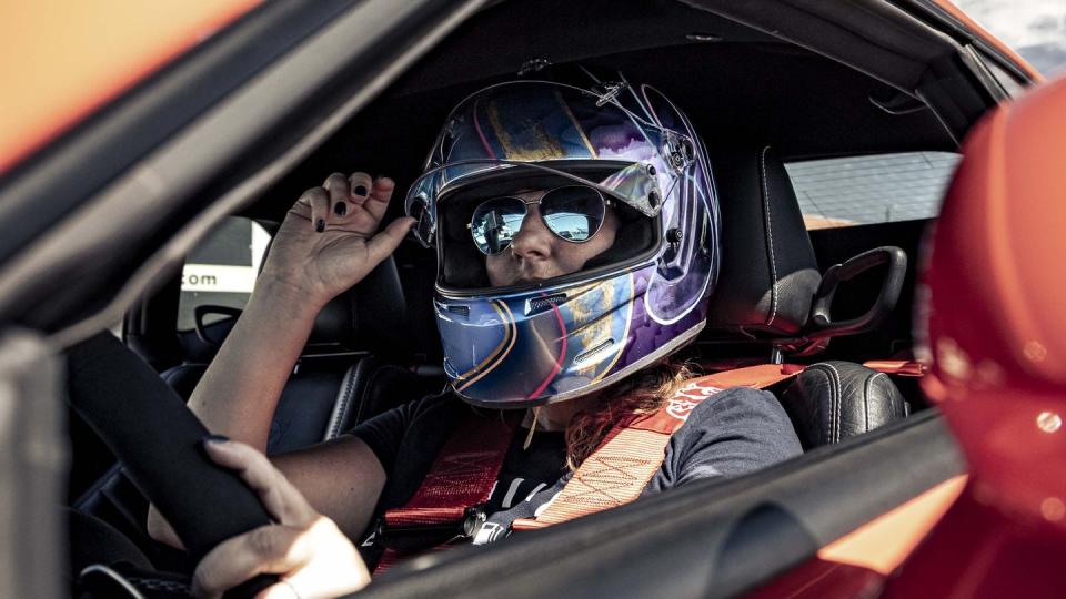 a woman in a helmet and goggles in a car