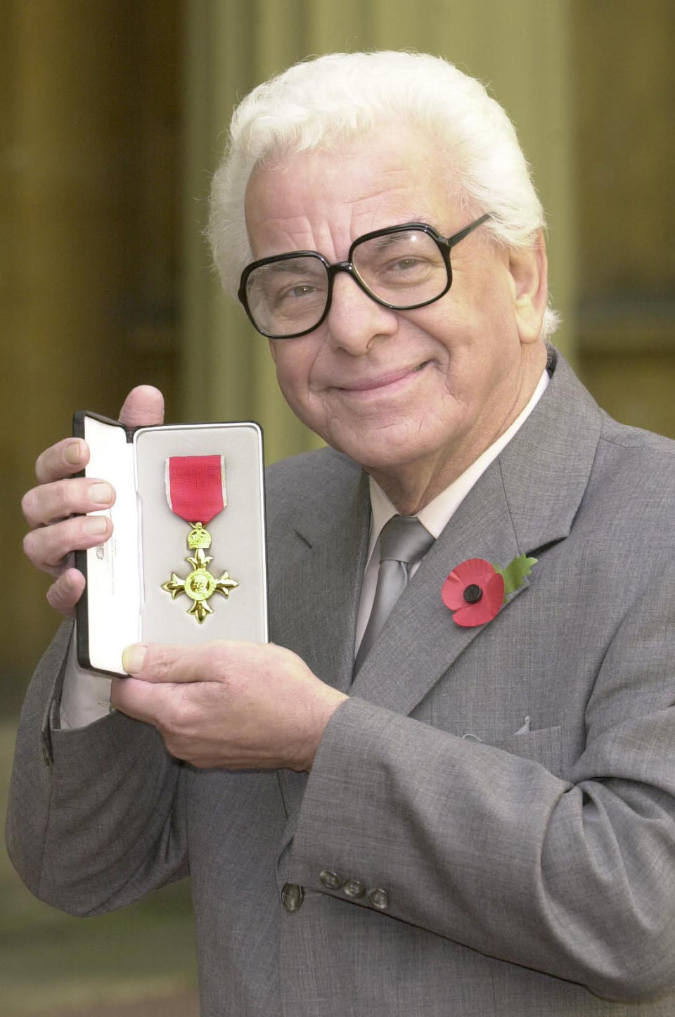 Barry Cryer shows off his OBE awarded to him by the Queen at Buckingham Palace. 