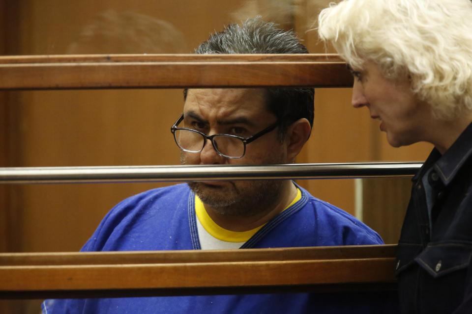 Naason Joaquin Garcia, left, appears with his attorney in court in Los Angels, Calif. on Monday, June 10, 2019. García, and his co-defendants face a 26-count felony complaint that alleges crimes including child rape, statutory rape, molestation, human trafficking, child pornography and extortion. The charges detail allegations involving three girls and one woman between 2015 and 2018 in Los Angeles County. (Ringo Chiu/Pool Photo via AP)