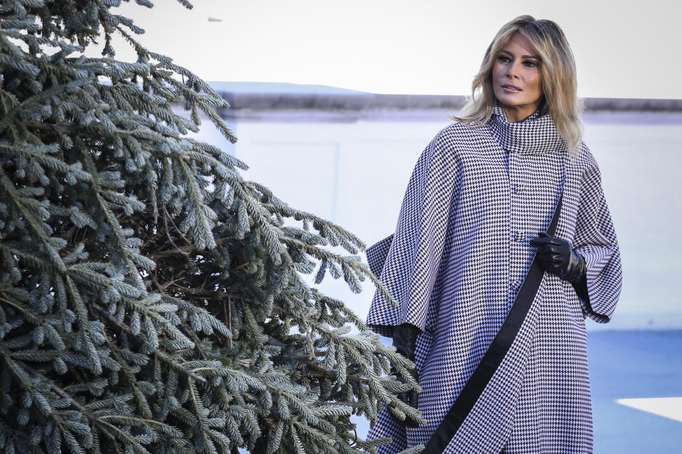 Melania Trump in a gingham coat inspecting the White House Christmas Tree