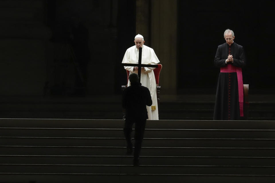 Pope Francis presides over the Via Crucis – or Way of the Cross – ceremony in St. Peter's Square empty of the faithful following Italy's ban on gatherings to contain coronavirus contagion, at the Vatican, Friday, April 10, 2020. The new coronavirus causes mild or moderate symptoms for most people, but for some, especially older adults and people with existing health problems, it can cause more severe illness or death. (AP Photo/Alessandra Tarantino)