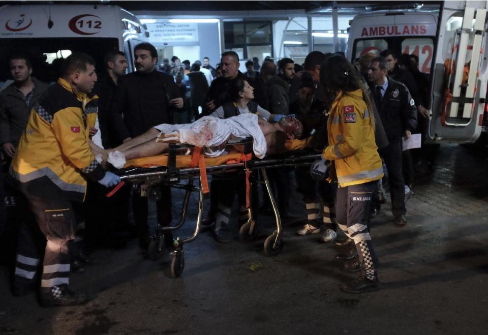 Rescue and medics carry a wounded person after attacks in Istanbul, late Saturday, Dec. 10, 2016. Two explosions struck Saturday night outside a major soccer stadium in Istanbul after fans had gone home, an attack that wounded about 20 police officers, Turkish authorities said. One of the blasts was thought to be a car bomb. Turkish authorities have banned distribution of images relating to the Istanbul explosions within Turkey.(AP Photo/Cansu Alkaya)