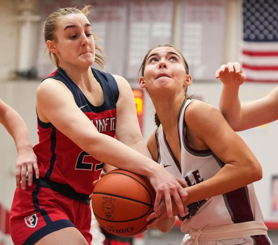 Danville's forward Gabi Pigecella (20) attempts to score against Plainfield Quakers forward Kara Olejnik (23) on Saturday, Jan. 6, 2024, during the game at Danville Community High School in Danville.