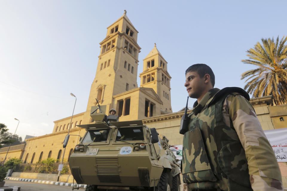 An Egyptian army armored vehicle secures St. Mark Cathedral in Cairo, Egypt, Monday, Jan. 6, 2014 ahead of Coptic Christmas Eve mass. Egyptian authorities put up a heavy security cordon around the Coptic cathedral in Cairo hours before Christmas Eve mass, using bomb-sniffing dogs, metal detectors and officers. (AP Photo/Amr Nabil)