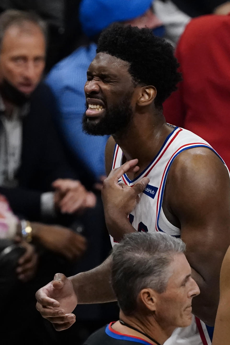 Philadelphia 76ers center Joel Embiid, top right, reacts after being injured during the second half of Game 6 of an NBA basketball Eastern Conference semifinal series against the Atlanta Hawks, Friday, June 18, 2021, in Atlanta. Embiid reminded in the game. (AP Photo/John Bazemore)