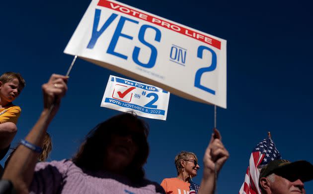 Demonstrators hold signs during a rally encouraging voters to vote yes on Amendment 2, which would add a permanent abortion ban to Kentuckys state constitution. (Photo: STEFANI REYNOLDS via Getty Images)