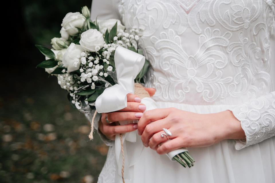 Beauty Wedding Bouquet Of Rose Flowers And Eucalyptus Branches In Bride's Hands