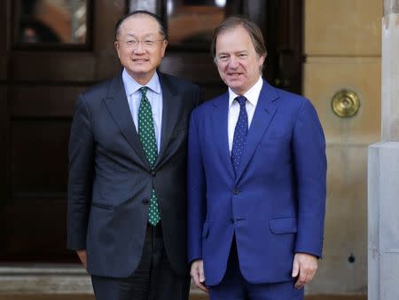 President of the World Bank Jim Yong Kim (L) is met by Britain's Foreign Office minister Hugo Swire as he arrives at a summit on corruption at Lancaster House in central London, Britain, May 12, 2016. REUTERS/Paul Hackett