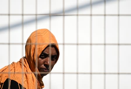 Migrants wait to embark a ferry to the mainland, in Lampedusa