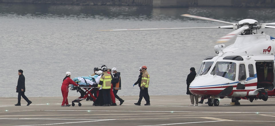 South Korean opposition leader Lee Jae-myung, is transported on a stretcher to a hospital at a heliport in Seoul, South Korea, Tuesday, Jan. 2, 2024. Lee was stabbed in the neck by an unidentified knife-wielding man during a visit Tuesday to the southeastern city of Busan, police said. (Seo Dae-won/Yonhap via AP)