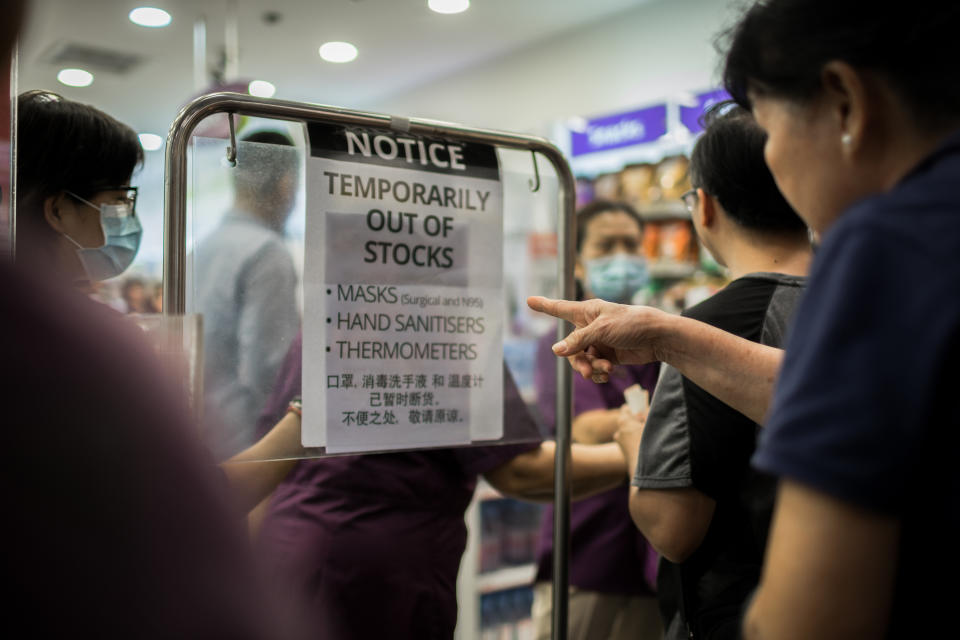 SINGAPORE - 2020/02/14: People lines up to purchase protective face masks in a local pharmacy in Singapore. Singapore declared the COVID-19 outbreak as Code Orange on February 7, 2020. (Photo by Maverick Asio/SOPA Images/LightRocket via Getty Images)