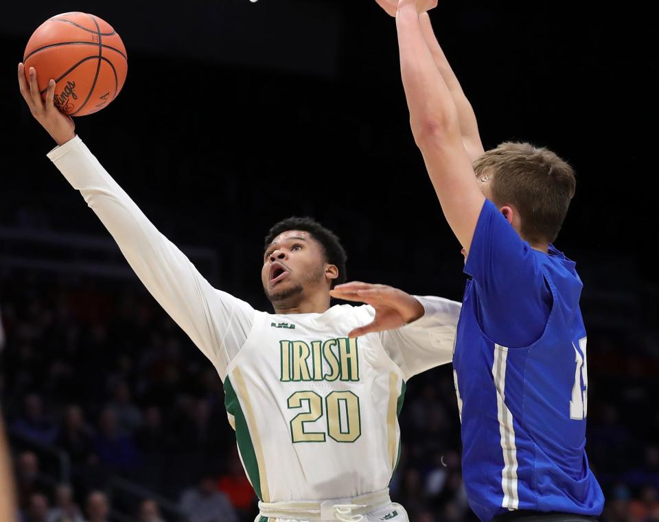 STVM guard Ramar Pryor, left, attempts a layup ahead of Gilmour Academy forward Ryan Mueller during the second half of the OHSAA Division II state championship at UD Arena on Sunday.