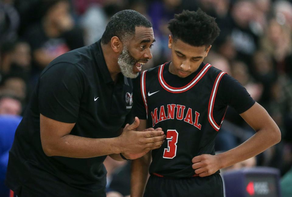 Manual head coach Miquel Coleman talks with Manual's Malachi Coleman Friday night. Feb. 10, 2023