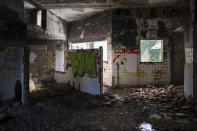 The interior of the destroyed Igman Hotel, built to house the competitors of the Sarajevo Winter Olympic Games, on Igman mountain near Sarajevo, Bosnia, Wednesday, Feb. 7, 2024. Sarajevo is paying tribute this week to one of its most glorious moments: the two weeks of February in 1984 when it staged an impeccable Winter Olympic Games. While taking the nostalgic trip down memory lane, Bosnian Olympians say they are looking to the future with hope to again pull off an “apparently impossible feat” and reignite the Olympic flame over Sarajevo in 2032. (AP Photo/Armin Durgut)