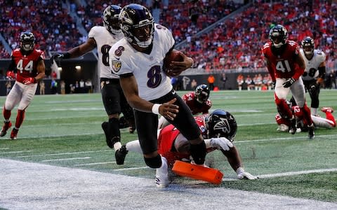 Lamar Jackson #8 of the Baltimore Ravens rushes for a touchdown past Grady Jarrett #97 of the Atlanta Falcons at Mercedes-Benz Stadium - Credit: Photo by Kevin C. Cox/Getty Images