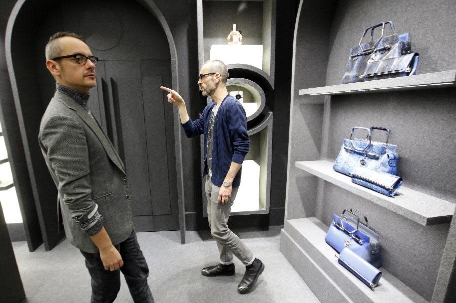 Netherlands' fashion designers Rolf Snoeren, left, and Viktor Horsting look for the final touches in their new Viktor and Rolf shop in Paris, Wednesday, Dec. 11, 2013. Viktor&Rolf, the Amsterdam-based avant-garde fashion house, opens its first ever flagship boutique in France in Paris. (AP Photo/Francois Mori)