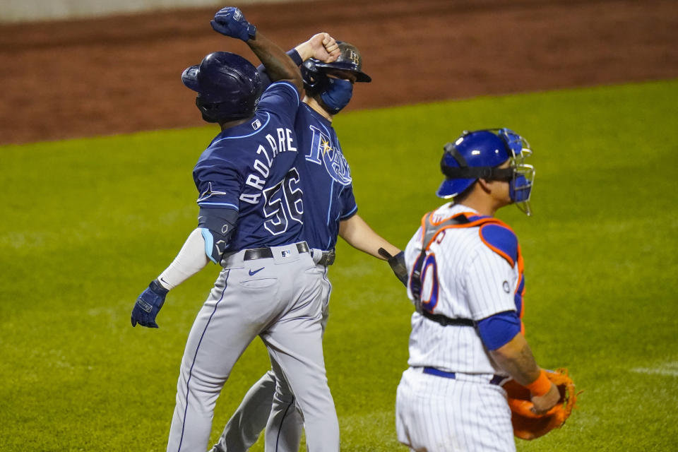 Tampa Bay Rays' Randy Arozarena (56) celebrates with teammate Brandon Lowe after hitting a two-run home run while New York Mets catcher Wilson Ramos (40) reacts during the sixth inning of a baseball game Wednesday, Sept. 23, 2020, in New York. (AP Photo/Frank Franklin II)