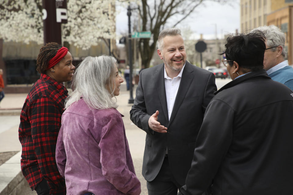 This photo provided by the Eric Sorensen for Illinois campaign shows Sorensen talking with a group of people. on Thursday, Nov. 10, 2022, a battleground race between newbies aiming to fill retiring U.S. Rep. Cheri Bustos' seat in Illinois' 17th Congressional District tipped in Democrat Sorensen's favor, representing a key win for the party as it tries to maintain control of Congress. (Eric Sorensen for Illinois campaign via AP)