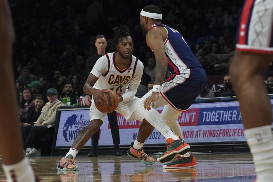 Cleveland Cavaliers guard Darius Garland (10) drives on Brooklyn Nets forward Bruce Brown (1) during the second half of an NBA basketball game, Friday April 8, 2022, in New York. (AP Photo/Bebeto Matthews)