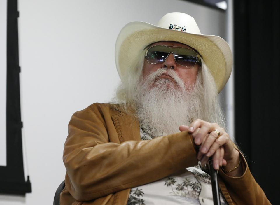 Leon Russell sits with his hands on his cane during a news conference in Tulsa, Okla., Tuesday, Jan. 29, 2013. The Oklahoma Historical Society has acquired a large collection of works by the legendary musician and native Oklahoman that are intended for display in a planned pop culture museum in Tulsa. (AP Photo/Sue Ogrocki)