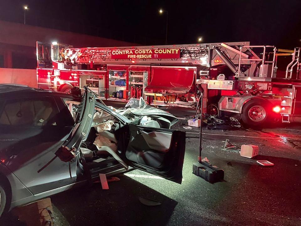 This photo released by Contra Costa County Fire Protection District shows the scene of a fatal accident involving a Tesla and Contra Costa County fire truck early Saturday morning, Feb. 18, 2023, in Contra Costa, Calif. Fire officials said the Tesla driver was killed and a passenger was critically injured Saturday when the car plowed into the fire truck parked on a Northern California freeway to shield a crew clearing another accident. (Contra Costa County Fire Protection District via AP) (Contra Costa County Fire Protection District)