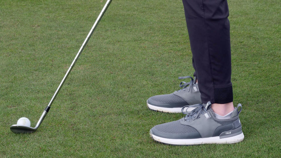 Dan Parker hitting a wedge on the course wearing the True Linkswear Lux Hybrid golf shoe