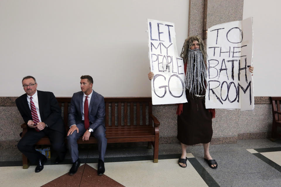 FILE - John Erler protests as the Senate State Affairs Committee begin hearings about Senate Bill 6 at the Texas Capitol, Tuesday, March 7, 2017, in Austin, Texas. The the transgender "bathroom bill" would require people to use public bathrooms and restrooms that correspond with the sex on their birth certificate. (AP Photo/Eric Gay, File)