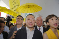 Occupy Central leaders, from left, Chan Kin-man, wearing glasses, Benny Tai, Chu Yiu-ming and Tanya Chan enter a court in Hong Kong, Wednesday, April 24, 2019. The court is preparing to sentence nine leaders of massive 2014 pro-democracy protests convicted last month of public nuisance offenses. The sentences to be handed down Wednesday are seen as an effort by the government of the semi-autonomous Chinese territory to draw a line under the protests. (AP Photo/Kin Cheung)