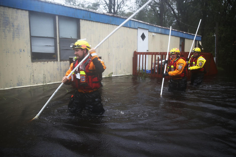 Boone County Fire Rescuers check for occupants in a home surrounded by floodwaters&nbsp;in&nbsp;Bolivia.