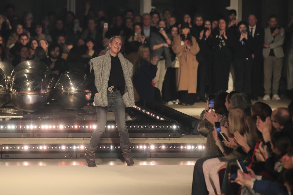 Designer Isabel Marant accepts applause after her fashion collection during Women's fashion week Fall/Winter 2020/21 presented in Paris, Thursday, Feb. 27, 2020. (AP Photo/Michel Euler)